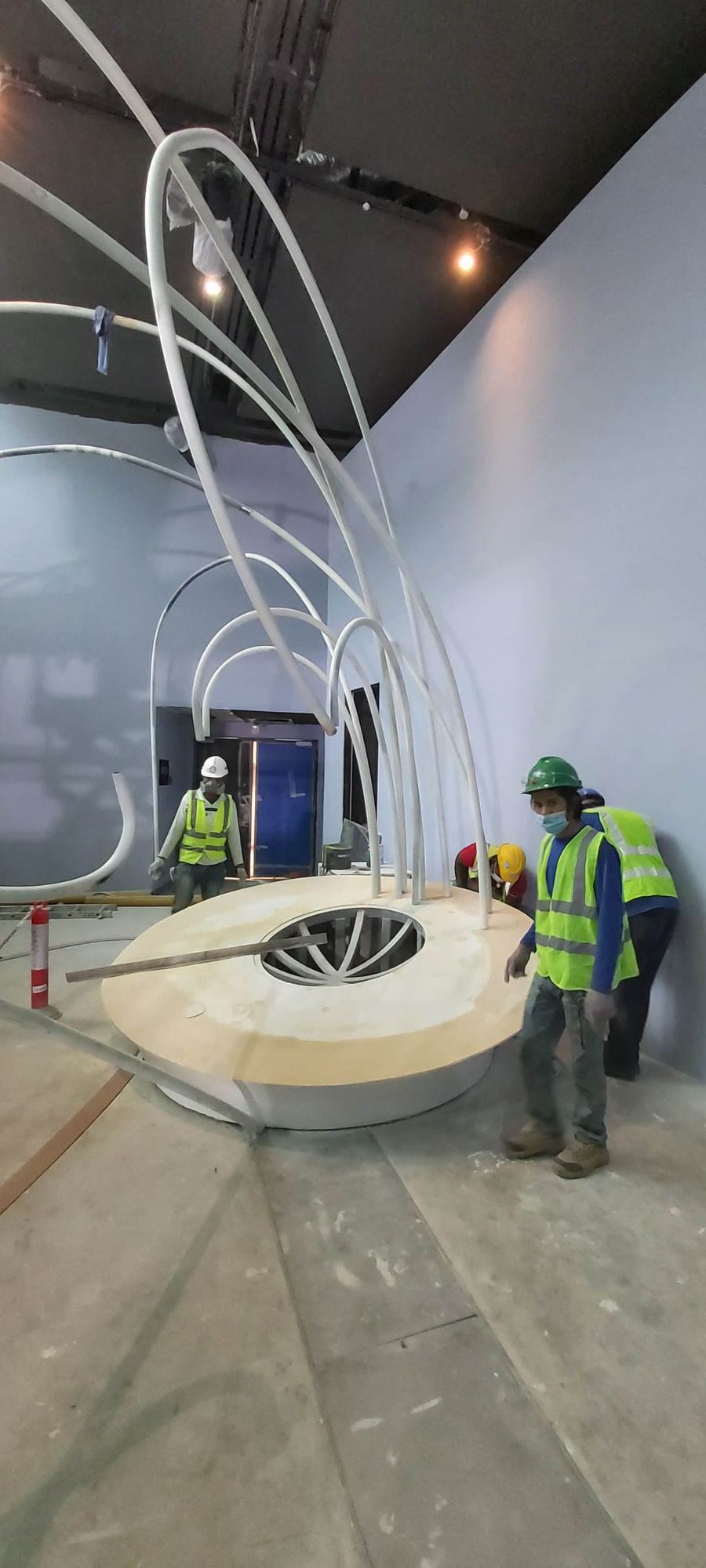 Spherical Live Coral Tank at Expo 2020 Dubai: Engineering a Living Reef for the Terra Pavilion 5 Installation team beside the circular plinth and sculptural white tubes for the spherical coral tank at Expo 2020 Dubai