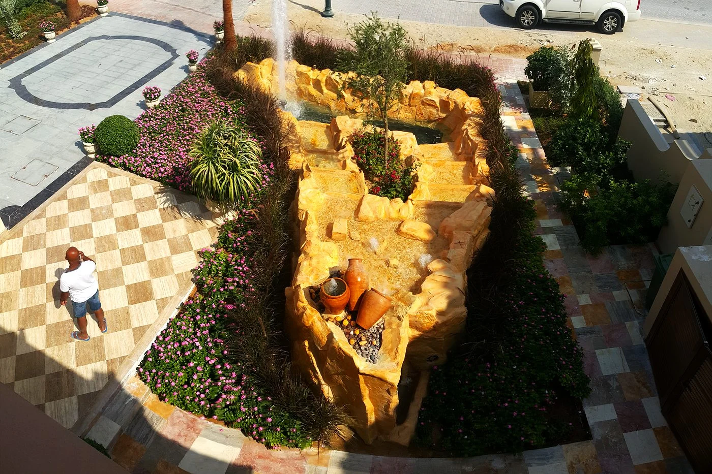 Aerial view of a sandstone fountain feature in a villa community