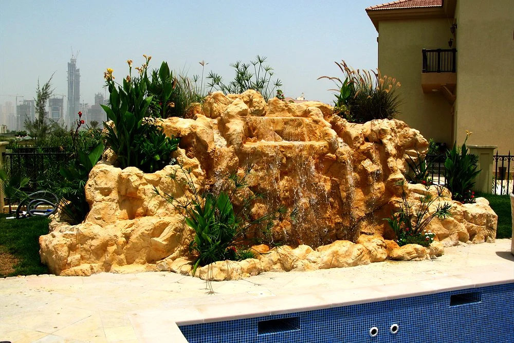 Outdoor Waterfall Design: Natural Rock, Artificial Rock and Spillways 2 Artificial sandstone waterfall beside a villa pool