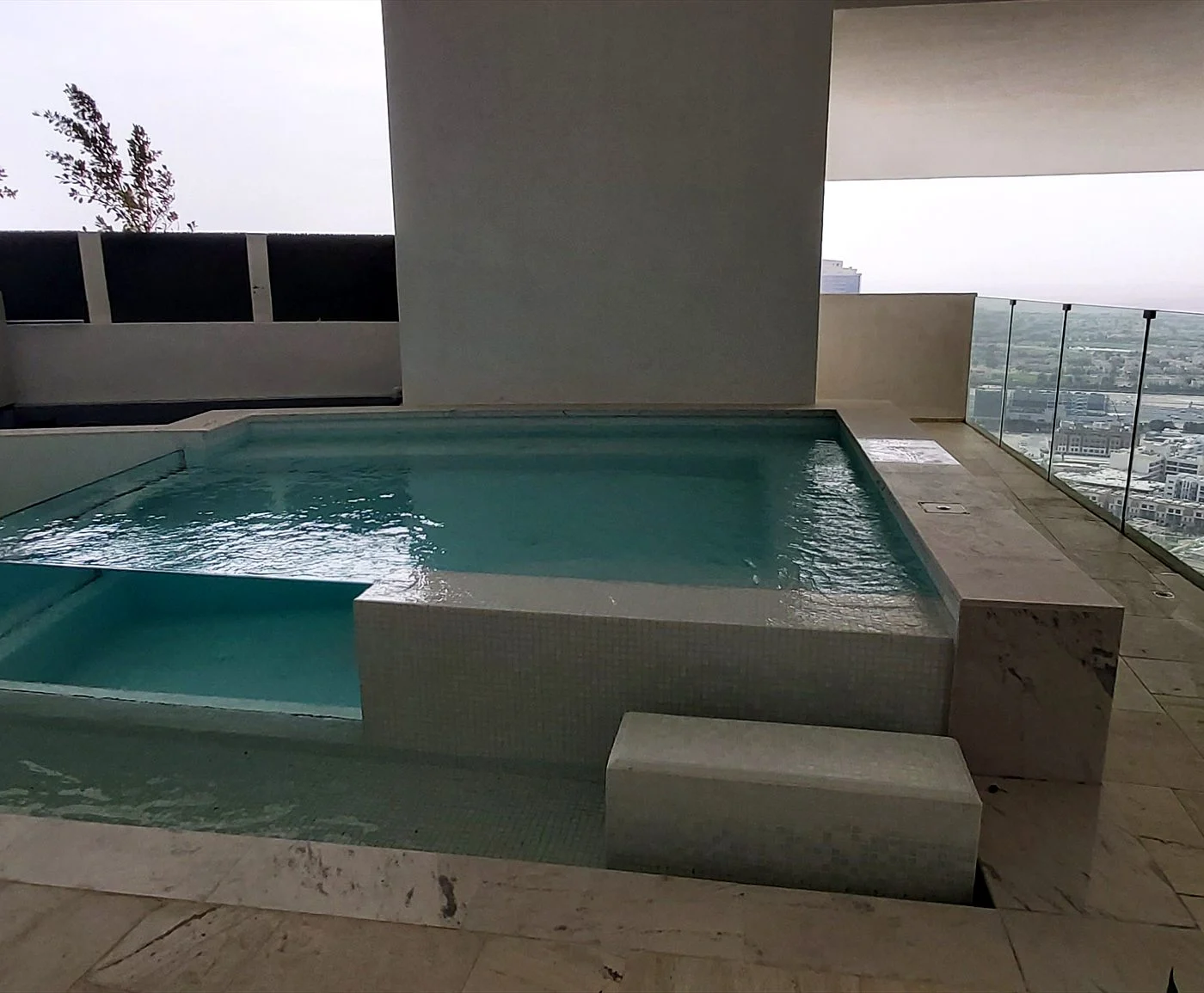 Compact terrace plunge pool with an acrylic viewing panel