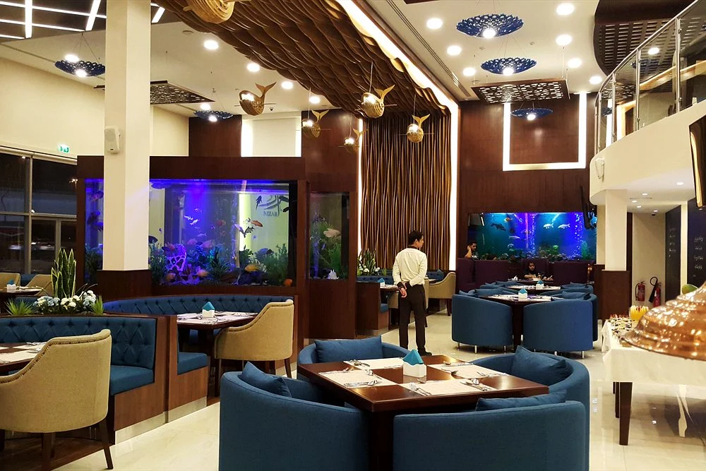Commercial Aquariums for Hotels, Restaurants and Offices in Dubai 2 Dining room with aquarium partitions and timber ceiling