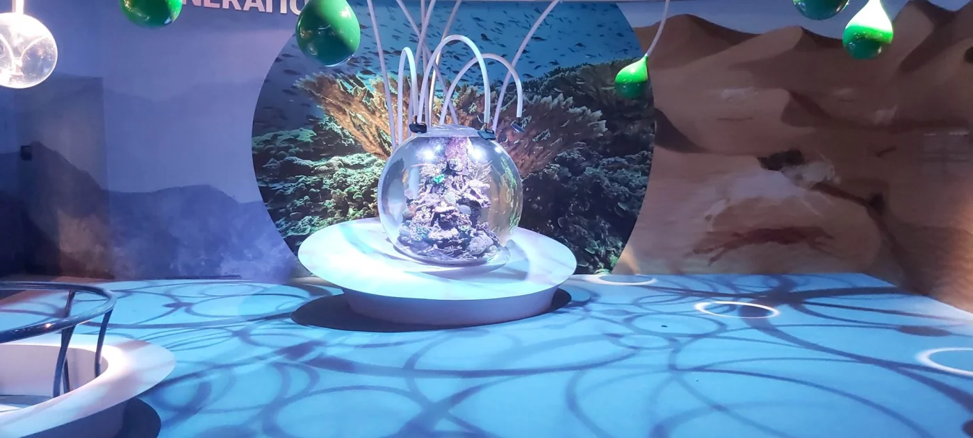 Live reef aquascape inside a 1,500 mm spherical coral tank lit by LED arrays at Expo 2020 Dubai