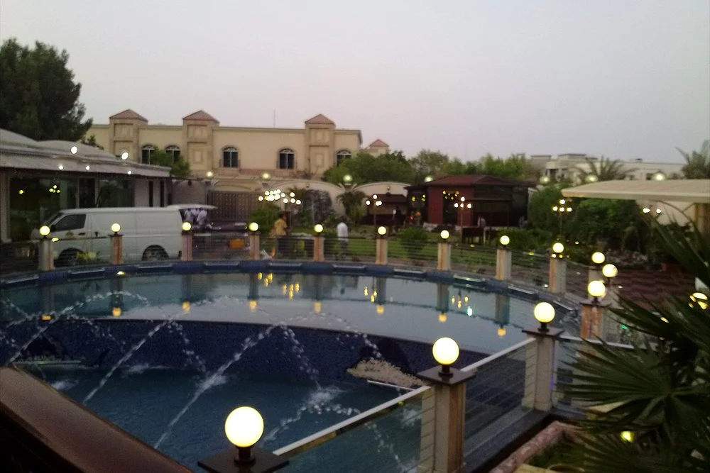 Fountain and Water Feature Maintenance Checklist for the UAE 2 Fountain jets in a garden pond lit at dusk