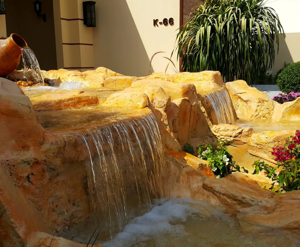 Fake Rock Covers: Hide Pool Pumps & AC Units in Style 2 Hand-finished artificial sandstone rock cascade in a garden