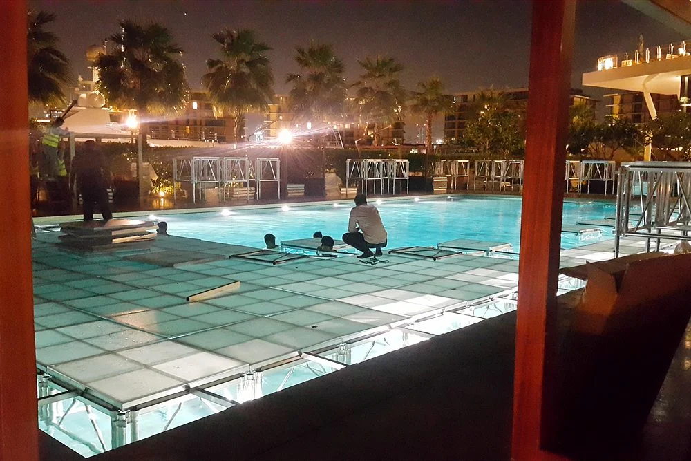 Do You Need a Permit for a Plunge Pool in Dubai? 2 Illuminated glass-deck pool at night in Dubai
