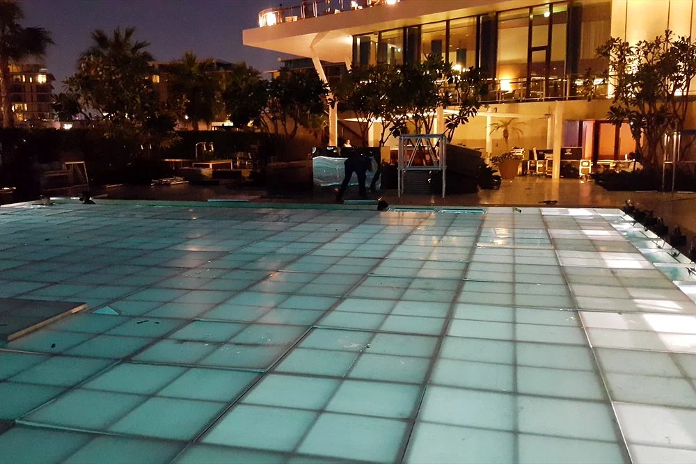 Pool Chiller in the UAE: Sizing, Running Cost and Cold Plunge Use 1 Illuminated glass-floor pool at a Dubai hotel at night