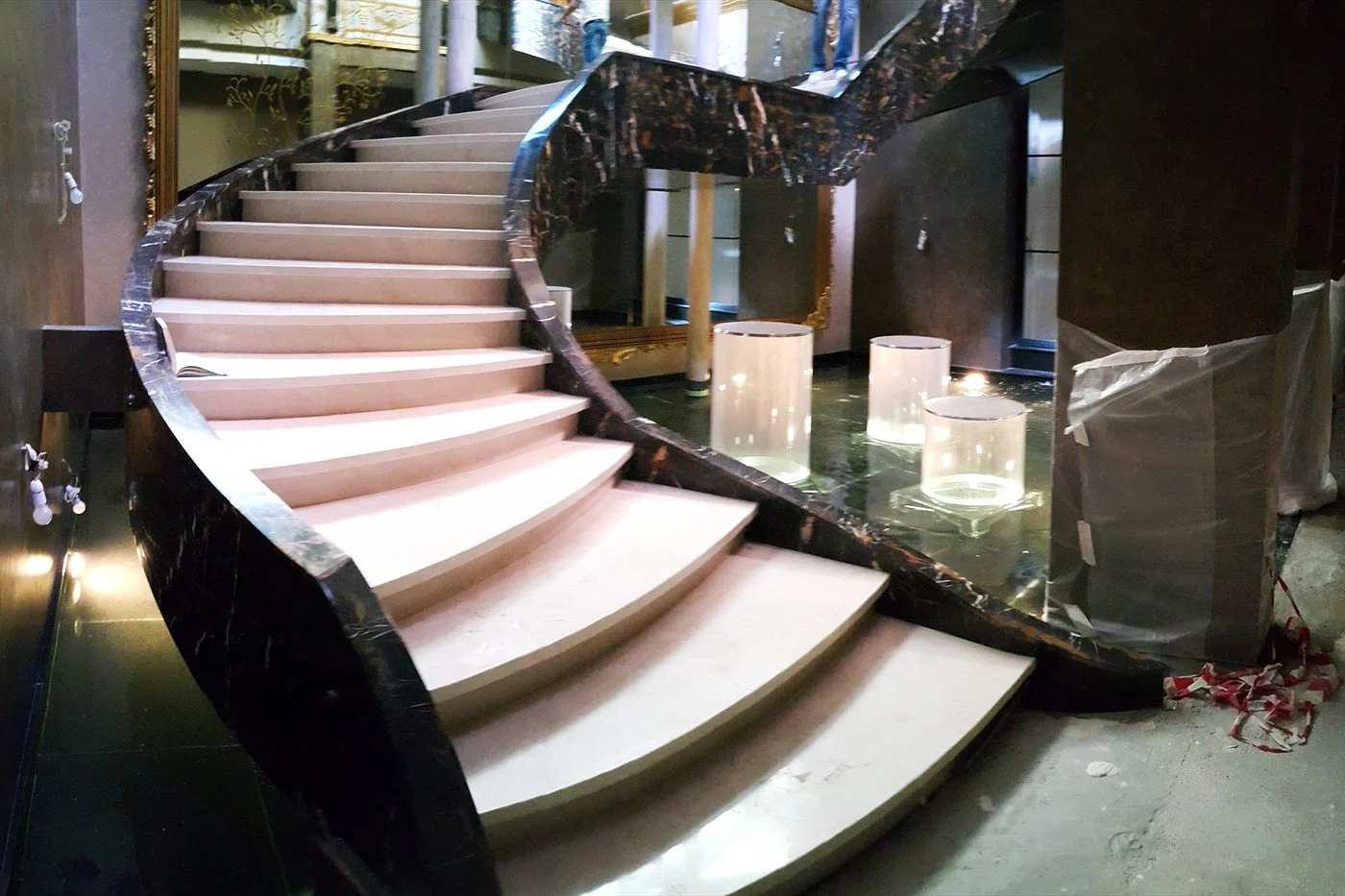 Indoor pond beneath a spiral marble staircase
