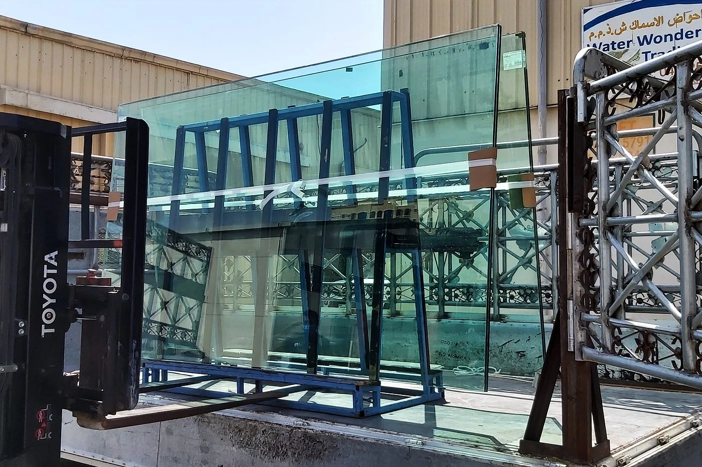 Large glass panels moved by forklift at the Water Wonders workshop