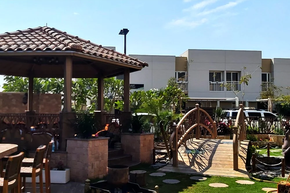 Koi Pond Design Ideas for Dubai Villas: Modern, Japanese and Raised 1 Pergola and pond area in a villa garden in the UAE