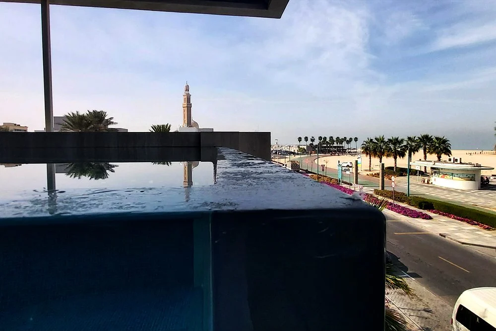 Small Pool Ideas for Dubai Townhouses, Courtyards and Rooftops 2 Raised pool with a glass edge overlooking a Dubai beachfront