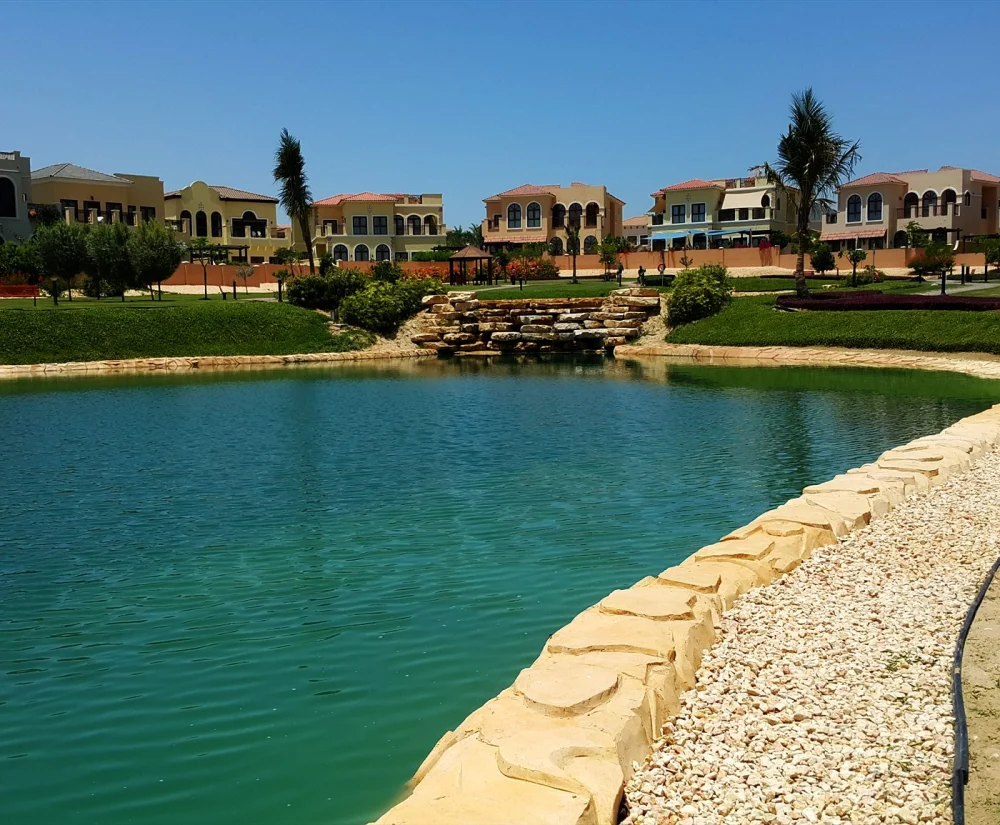 Concrete vs Liner Pond: Waterproofing for UAE Heat 2 Rock edging around a lake in a UAE villa community