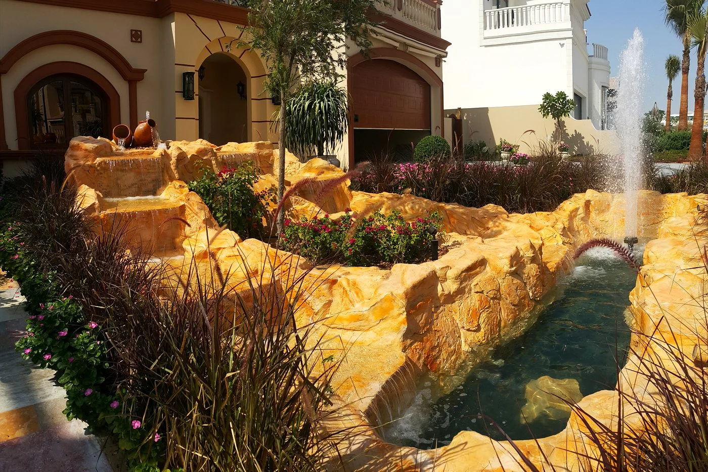 Sandstone-look rock channel and fountain in a villa courtyard