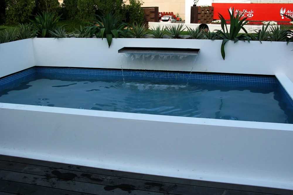 Plunge Pool Maintenance: Weekly Routine for the UAE 2 Small white plunge pool with a spill blade and planting