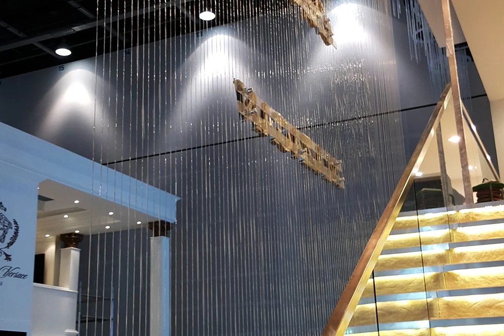 Commercial Water Features for Hotels, Malls and Developments in the UAE 2 String waterfall falling beside a lit glass staircase