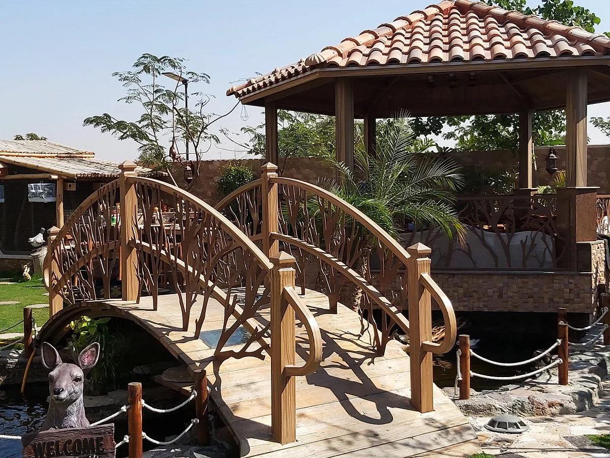 Villa koi pond with a gazebo and arched bridge