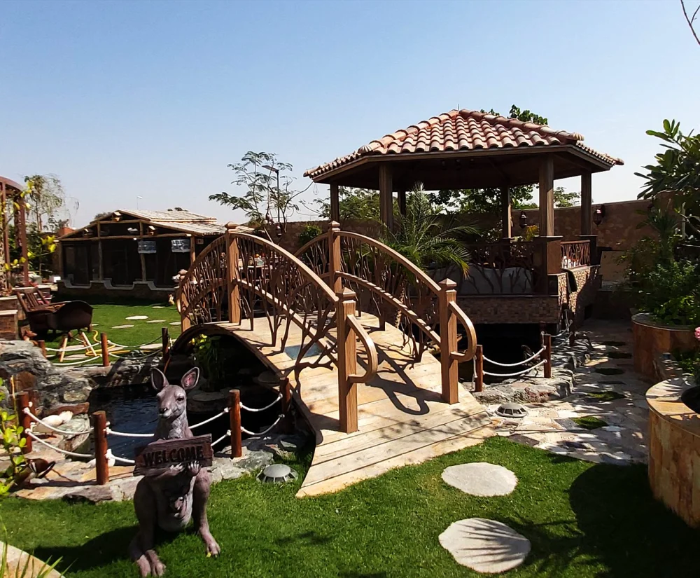 Aquarium & Koi Pond Emergency Plan for UAE Summers 2 Villa koi pond with a wooden bridge and gazebo